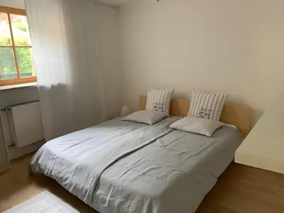 a bedroom with a large bed with two pillows at Hof Am Bach in Caldaro