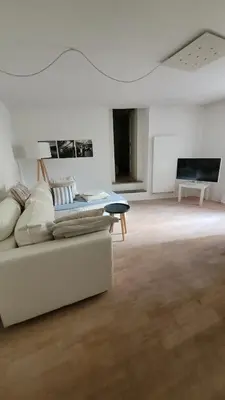a living room with a couch and a table at Hof Am Bach in Caldaro