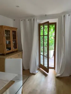 a kitchen with a glass table and a sliding door at Hof Am Bach in Caldaro