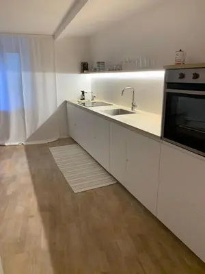 a kitchen with a sink and a microwave at Hof Am Bach in Caldaro
