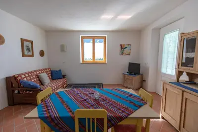 a living room with a table and a couch at On the River in Laives