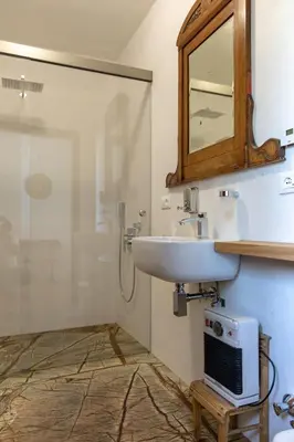 a bathroom with a sink and a mirror at On the River in Laives