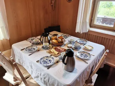 a table with blue and white dishes and a basket of food at Finhäusl in Aldino