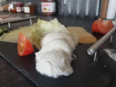 a piece of food sitting on top of a table at Aparthotel Malga in Caldaro