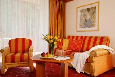 a living room with a couch and a table at Hotel Nocturnes in Naturno