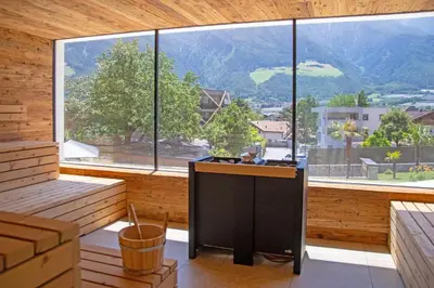 a kitchen with a large window with a view of a mountain at Hotel Nocturnes in Naturno