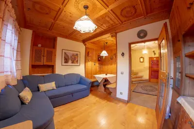 a living room with a blue couch and a table at Hotel Mehrhauser in Nalles