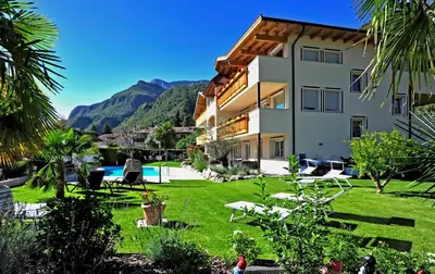 a large building with a yard with a pool at Hotel Mehrhauser in Nalles