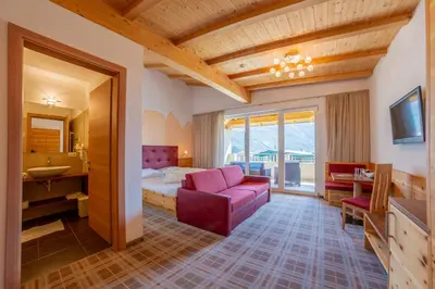 a hotel room with a bed and a bathroom at Hotel Mehrhauser in Nalles