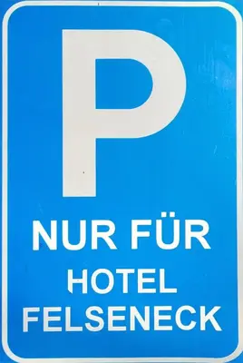 a blue and white parking sign with the letter p at Pension Felseneck in San Leonardo in Passiria