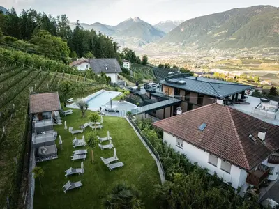 a bedroom with a large white bed in a room at Hotel Alpenrose in Schenna