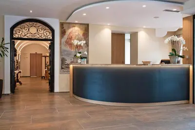 a lobby with a blue counter in a building at Hotel Wessobrunn in Merano