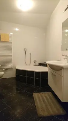 a bathroom with a tub and a sink and a shower at Residence Sonnberg in Perca