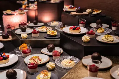 a bunch of desserts on plates on a table at Hotel Jägerheim 3S in Selva di Val Gardena