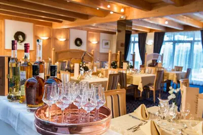a group of wine glasses on a table in a restaurant at Hotel Reischach in Brunico