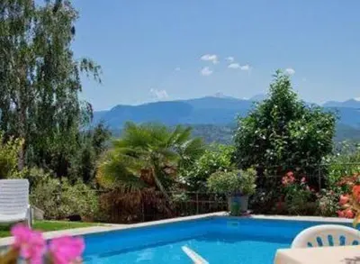 a swimming pool with a view of the mountains at Pension Steingarten in Appiano sulla Strada del Vino