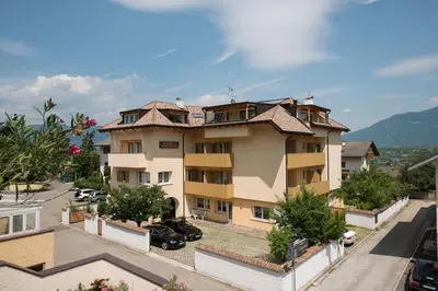 an apartment building with a view of a street at Pensione Penegalblick in Appiano sulla Strada del Vino
