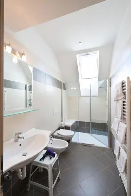a bathroom with a sink and a toilet and a shower at Pensione Penegalblick in Appiano sulla Strada del Vino