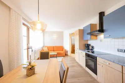 a kitchen and living room with a table and a couch at Ferienwohnungen Lanserhof in Appiano sulla Strada del Vino