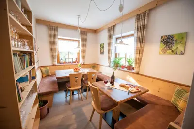 a room with a table and chairs and a dining room at Ferienwohnungen Lanserhof in Appiano sulla Strada del Vino