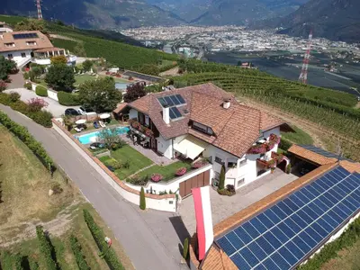 a house with a bunch of solar panels on it at Ferienwohnungen Lanserhof in Appiano sulla Strada del Vino