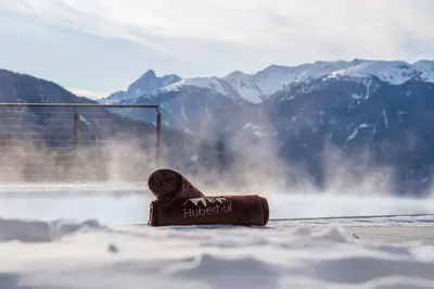 a swimming pool with a view of a mountain at Panoramahotel Huberhof in Maranza