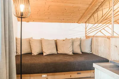 a bed in a room with a wooden ceiling at Ansitz Zehentner in Laion