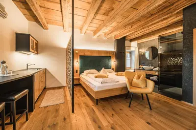 a hotel room with a bed and a kitchen at Ansitz Zehentner in Laion