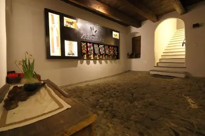 a room with a wall with bottles on the wall at Ansitz Zehentner in Laion