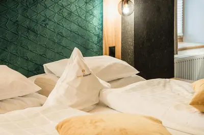 a group of white beds in a room at Ansitz Zehentner in Laion