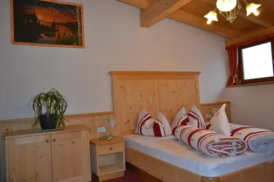 a bedroom with a bed with red and white pillows at Häuslerhof in Maranza