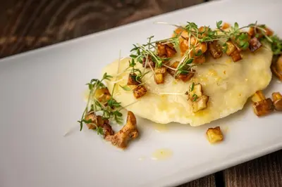 a white plate with a dish with food on it at Hotel Pfeiferhof in Maranza