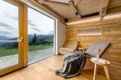 a room with a chair and a window with a view at Hotel Pfeiferhof in Maranza