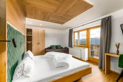 a bedroom with two beds and a window at Hotel Pfeiferhof in Maranza