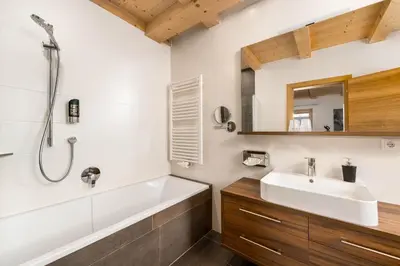 a bathroom with a tub and a sink and a shower at Hotel Pfeiferhof in Maranza