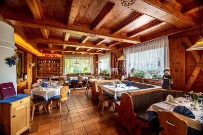 a group of chairs and tables on a patio at Hotel Salvan in Campitello di Fassa