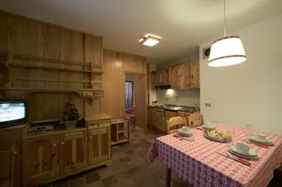 a kitchen with a table with a table cloth on it at Hotel Garni Gonzaga in Canazei