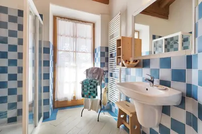 a bathroom with blue and white tiles and a sink at Maso Vaia in Cavalese