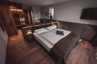 a bedroom with a bed with a pillow on it at Hotel Continental Dolomites in Selva di Val Gardena