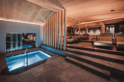 a hotel room with a swimming pool and a spa at Hotel Continental Dolomites in Selva di Val Gardena