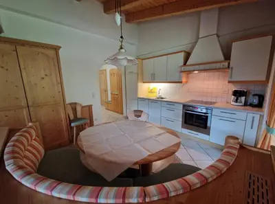 a kitchen with a wooden table in a room at Zollhof in Vipiteno