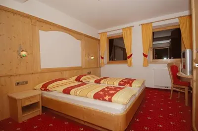 a bedroom with a large bed in a room at Zollhof in Vipiteno