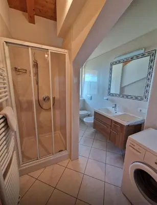 a bathroom with a shower and a sink at Zollhof in Vipiteno