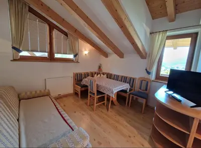 a small living room with a table and a couch at Zollhof in Vipiteno