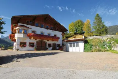 a large white house with a wooden roof at Zollhof in Vipiteno