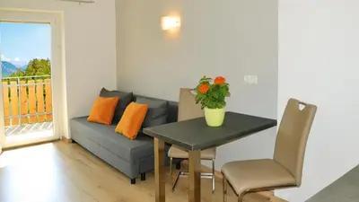 a living room with a couch and a table at Residence Ferienwohnungen Sonnegg in Vollan