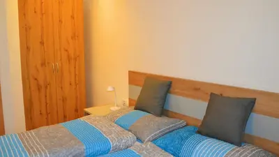 a bedroom with a bed with two pillows at Residence Ferienwohnungen Sonnegg in Vollan