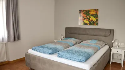 a bed with two pillows on it in a room at Residence Ferienwohnungen Sonnegg in Vollan