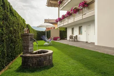 a fountain in the yard of a house at Appartamento Boschetto Giulia in Carano
