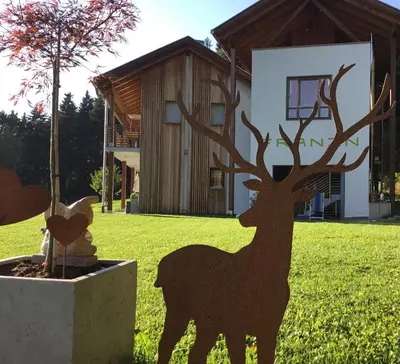 a statue of a deer in front of a house at Franzn Apartments in Petersberg